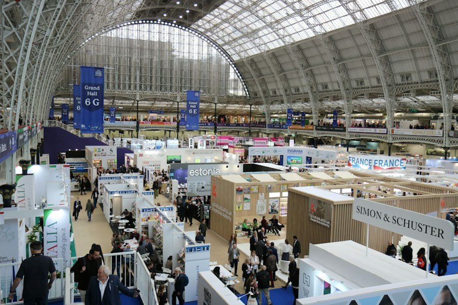 Busy trade exhibition hall with booths and visitors