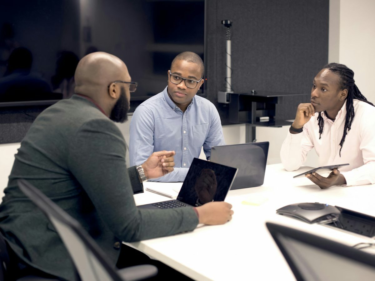 Colleagues reviewing plans at a meeting table